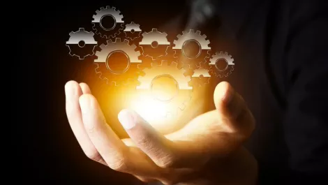 Man holding cogs to the universe