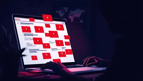 Moody laptop dark desk phishing inbox shadowy hand global cyber threats